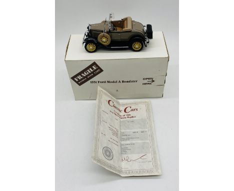 A boxed Danbury Mint 1931 Ford Model A Roadster die-cast model car with certificate