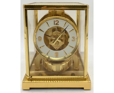 A Jaeger Le Coultre gilt brass Atmos Clock Serial Number 505375, glazed case with canted angles, circular white dial with Ara