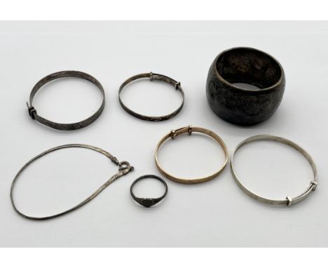 A small collection of silver bracelets along with a rolled gold bracelet, serviette ring etc. (silver weight 40.9g)