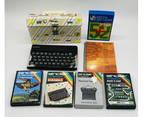 A vintage unboxed Sinclair ZX Spectrum computer console (no cables), along with instruction book and a selection of games