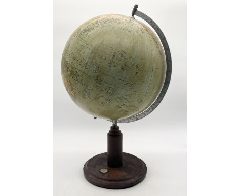 An early 20th century globe on turned wooden base with inset compass