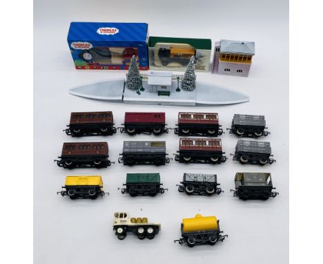 A collection of OO gauge model railway rolling stock and accessories including carriages, coal wagons, tanker wagon, boxed Ho