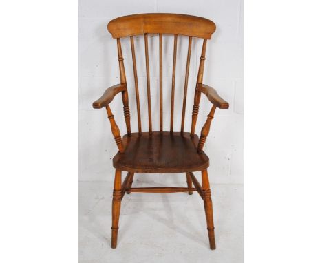 An antique elm Windsor stick back chair, with impressed mark 'W.V 56' to back of seat