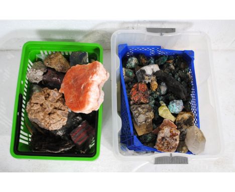 A collection of various raw geological specimens, including azurite, a large quantity of malachite, a slab of ruby zoistite, 