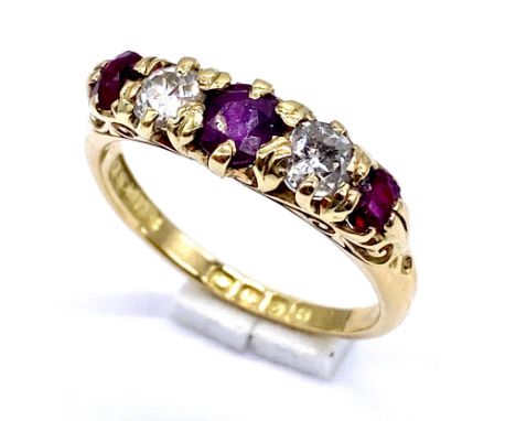 A turn of the century ruby and diamond stone ring set in 18ct gold, size N