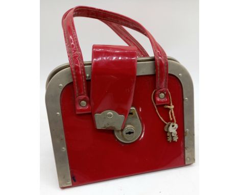 A vintage retro plastic handbag with aluminium edges.