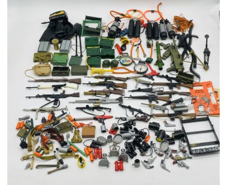A collection of vintage Action Man accessories including weapons, field radios, compasses. detonators, scuba diving equipment