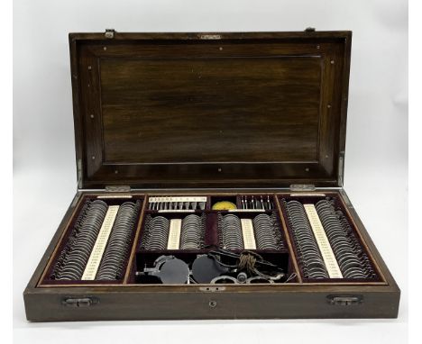 An early 20th century cased set of opticians lenses, accessories and tools 