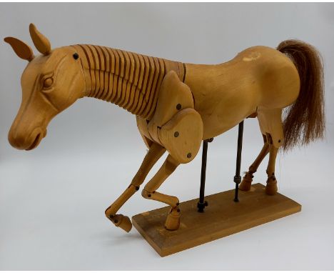 A vintage articulated wooden horse, artist`s model, horse hair tail, pivoting head, neck, leg joints, supported by adjustable
