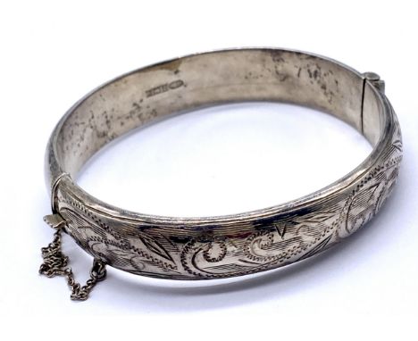 A vintage silver hinged bangle, with chased engraved decoration.