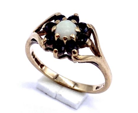 A 9ct gold garnet and opal ring, size K 1/2