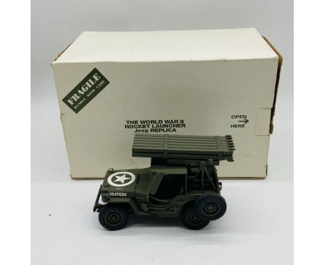 A boxed Danbury Mint die-cast model of a WWII Rocket Launcher Jeep replica, finished in military green with USA Star transfer