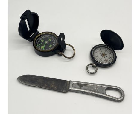 An early 20th century pocket compass along with an engineers' compass and a US military mess knife