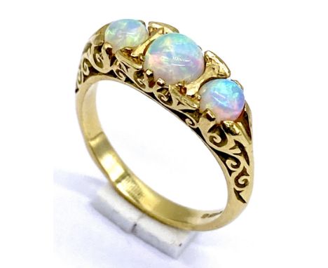 An opal three stone ring set in 18ct gold, size M 1/2