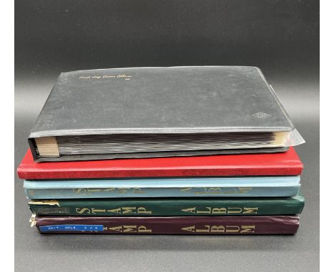 A collection of worldwide vintage stamps (not all pictured) across four albums along with an album of first day covers. 