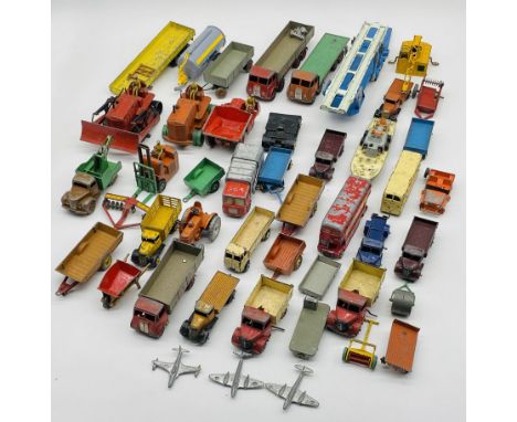 A collection of playworn vintage die-cast vehicles including bulldozers, forklift, coaches, breakdown trucks, lorries, trucks