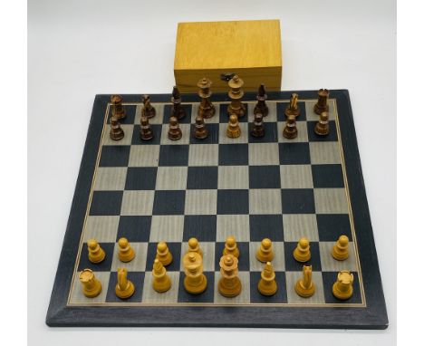 A vintage wooden chess set and board with storage box for pieces