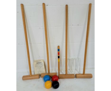 A vintage croquet set, complete with hoops, balls, instructions etc.