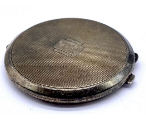 An unmarked silver compact