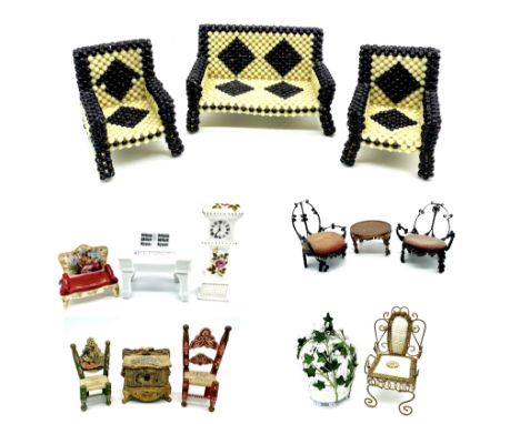 A collection of dolls house furniture including a birdcage, beaded garden chairs, ceramic piano, cooper style circular table,