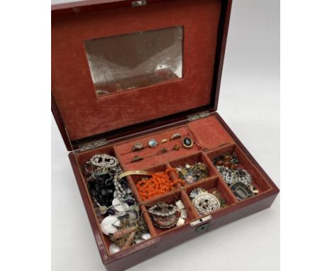 A collection of vintage costume jewellery including beads, brooches, rings, charm bracelet etc.