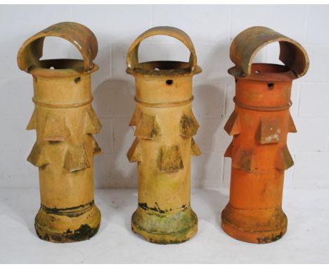 A pair of turn of the century weathered terracotta chimney pots, and one other similar, all marked 'Bourne Valley Pottery, Po