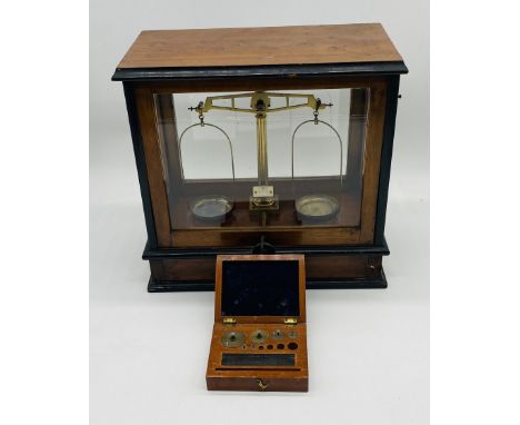 A set of L.Oertling Ltd balance scales in mahogany case with single drawer under - some weights missing