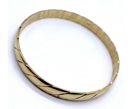 A 9ct gold bangle, weight 26.2g