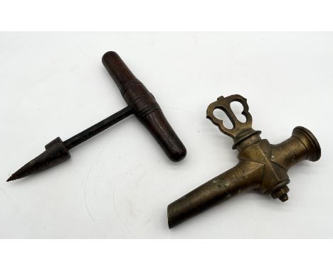 A large antique wooden handled corer/awl similar to a corkscrew, along with a large brass barrel tap or spigot 