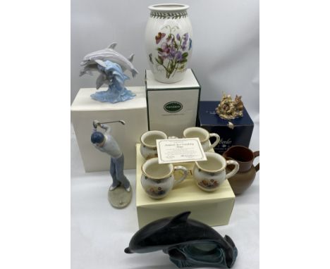 A collection of various china including Lenox Hundred Acre friendship mugs, Poole dolphin, Border Fine Art etc.