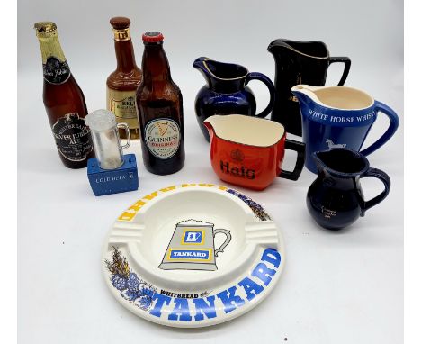 A collection of assorted breweriana items to include three wade pub jugs, Carlton ware Haig jug etc.