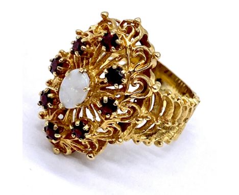 A 9ct gold dress ring set with opal and garnets, total weight 6.4g, size P