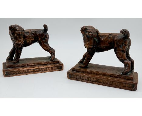 A pair of vintage copper bookends decorated with terriers, marked made in the USA.