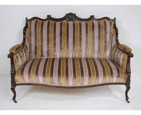 An Edwardian upholstered sofa, with carved decoration and cabriole legs - length 136cm
