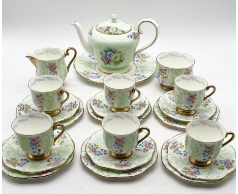 A Trentham pottery china tea service decorated in mint green with floral patterns includes teapot, milk jug, sugar bowl, six 