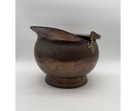 A vintage copper coal scuttle