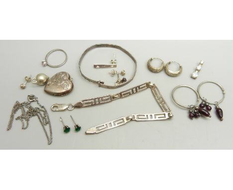 A silver fretwork bracelet, a child's silver bangle (a/f), a pair of silver hoop earrings, gold plated silver locket (plating