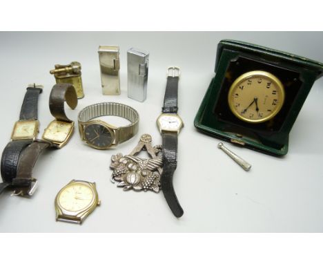 An 8 day travel clock, wristwatches, lighters and a Masonic medal, inscribed 'Presented to the lodge by Bro. E. H. Lee, First