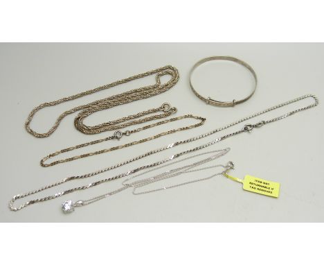 A collection of silver jewellery - a 24cm figaro bracelet, a child's bangle, a pendant and chain and two necklaces, 29g 