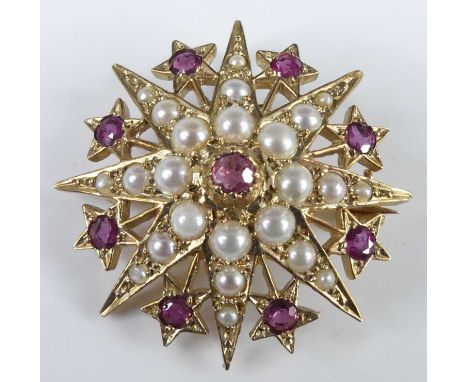A Victorian style 9ct gold ruby and seed pearl set radiating star brooch, late 20th century, dia. 3cm, 5.8g