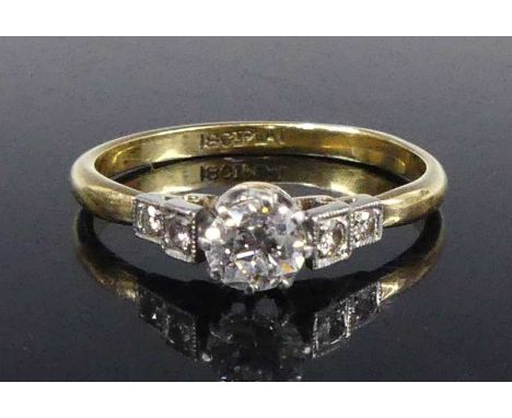 An 18ct gold and platinum diamond solitaire ring, the claw set round brilliant weighing approx 0.37 carats, the shoulders eac