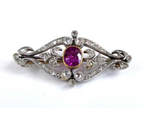 A yellow and white metal, pink sapphire and diamond scrollwork panel brooch, the centre oval pink sapphire in a millegrain se