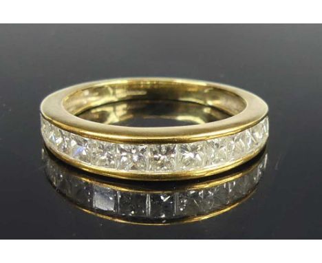 A 9ct yellow gold diamond half-hoop eternity ring, comprising 12 graduated princess cut diamonds in channel settings, diamond