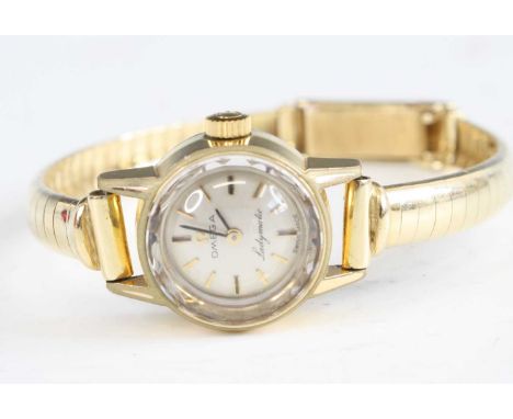 A vintage lady's Omega Ladymatic gold plated manual wind wristwatch, having a signed silvered dial with baton markers, case d