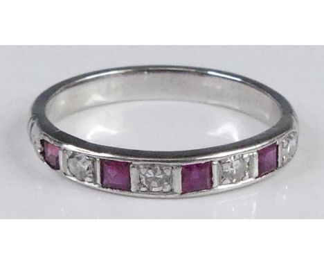 A white metal ruby &amp; diamond set half eternity ring, arranged as four square cut rubies, and four round cut diamonds, tot
