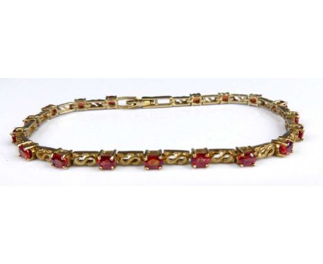 A modern 9ct gold Malawi ruby set bracelet, the eighteen oval cut rubies being four-claw set, total ruby weight approx 4.33 c