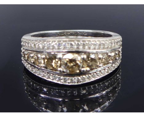 An Iliana 18ct white gold diamond set dress ring, the elliptical setting with nine graduated brilliant cut tinted diamonds, t