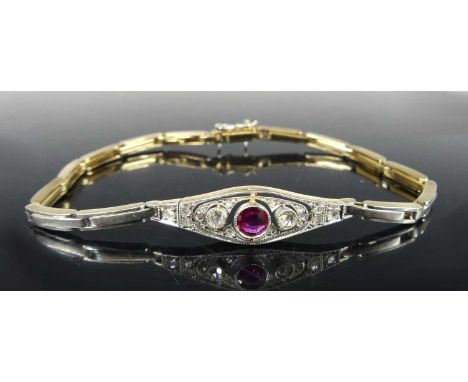 A yellow and white metal, ruby and diamond set bracelet, the lozenge setting bezel set with a round cut ruby weighing approx 
