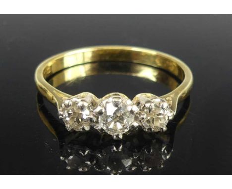 An 18ct yellow and white gold diamond three-stone ring, comprising three graduated Old European cut diamonds in claw settings