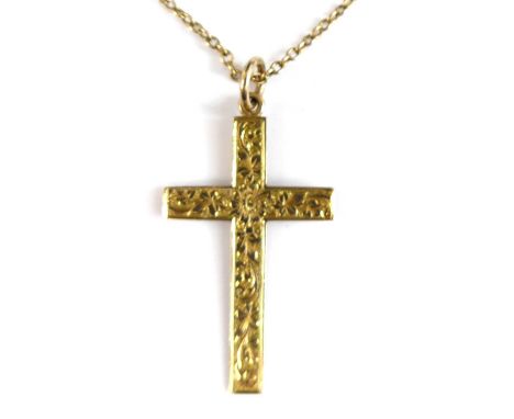 A 9ct yellow gold cross pendant, engraved with floral detail and attached to an oval trace link chain with bolt ring clasp, p